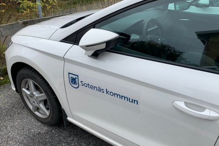 framdelen på en vit bil med Sotenäs kommun tryckt på dörren.